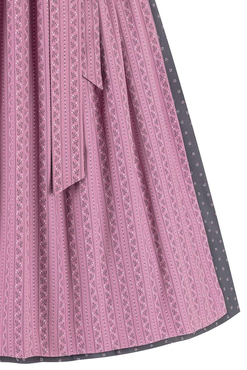 Rosa Dirndlschürze mit floralen Mustern von MOSER Trachten auf grauem Hintergrund.