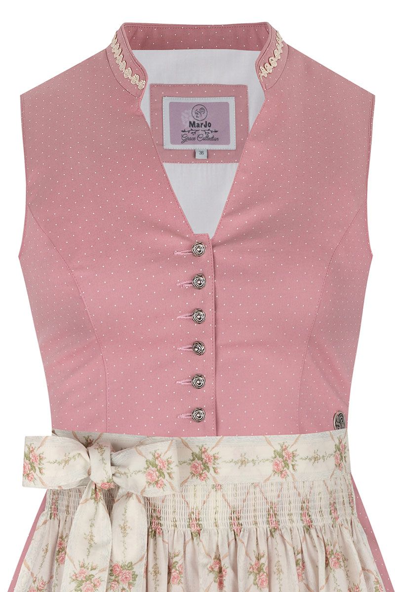 Pinkes Dirndl von MOSER Trachten mit weißen Punkten und geblümter Schürze.