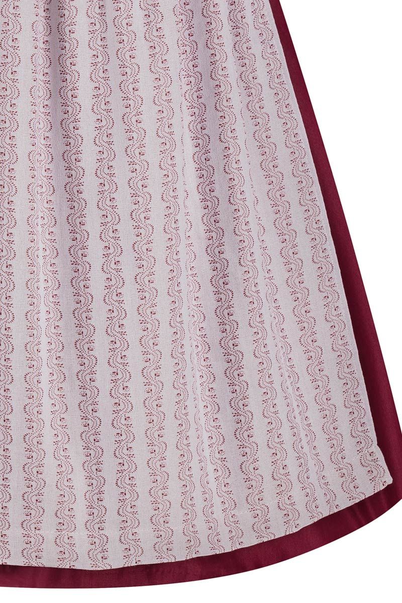 Roter Dirndlrock mit weißem, traditionellem Muster von MOSER Trachten.