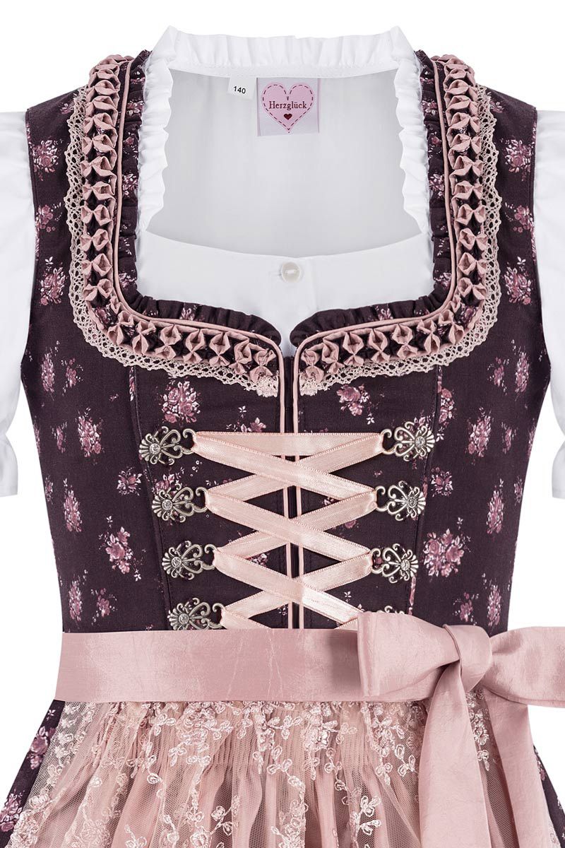 Elegantes Herzglück-Dirndl mit rosa Details und Spitzenapplikationen von Moser Trachten.
